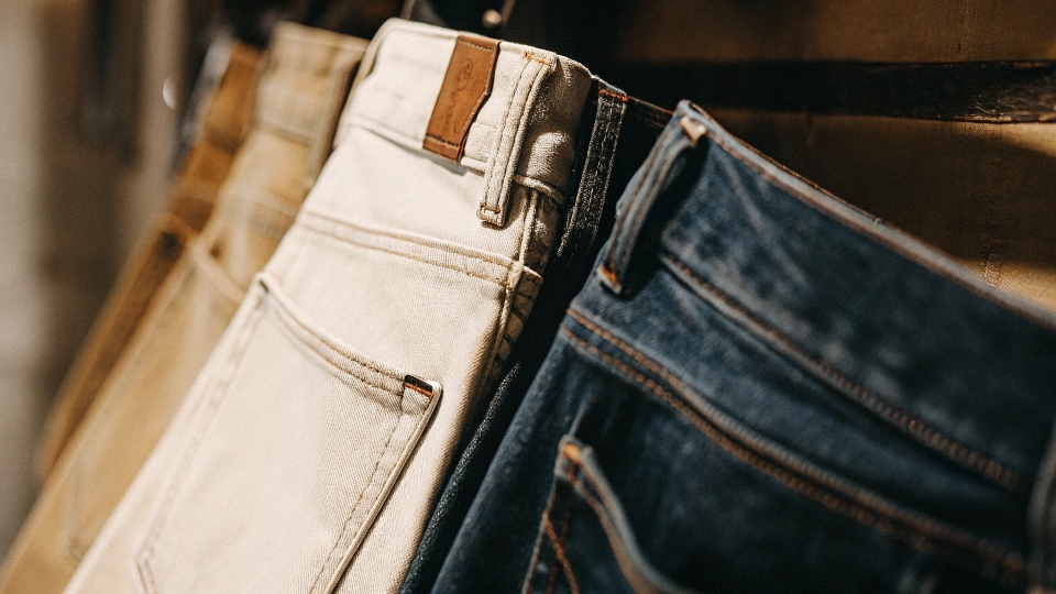 The iconic Levi's red tab on a jean pocket, with the broader denim fabric in the background.