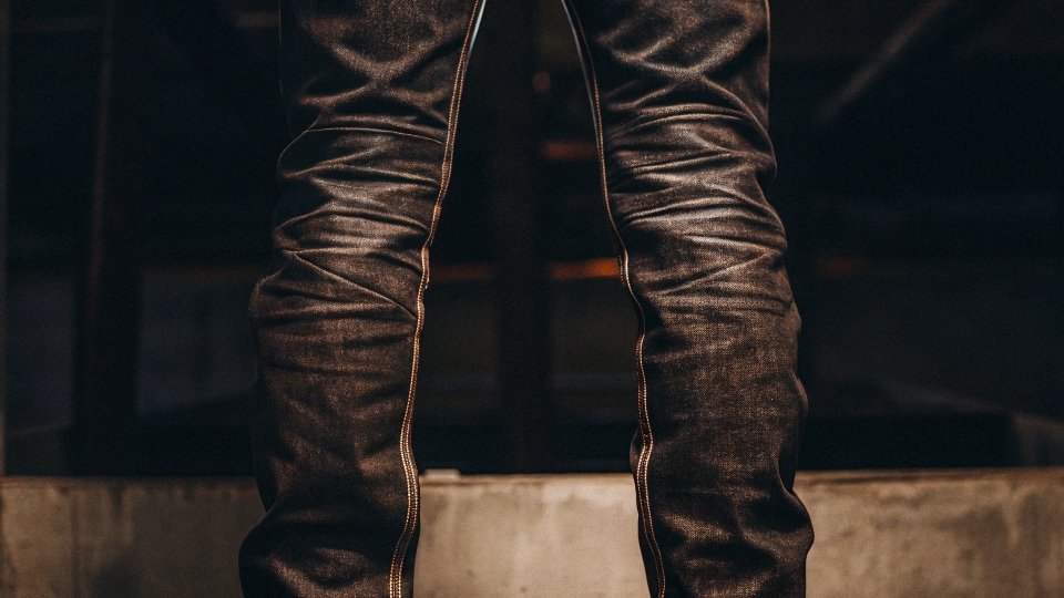 A pair of heavily starched jeans with a razor-sharp crease ironed down the center of each leg.