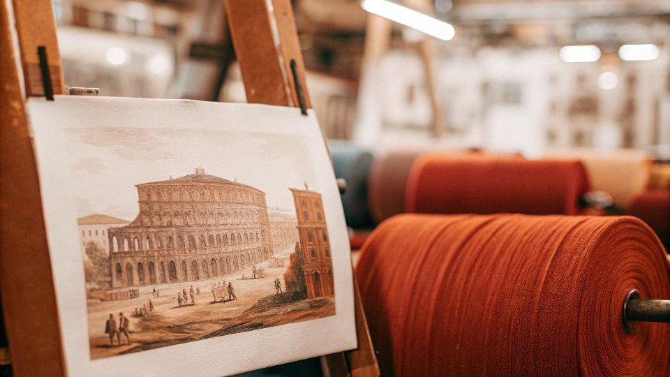 A historical painting or drawing of the French city of Nîmes, known for its textile production.