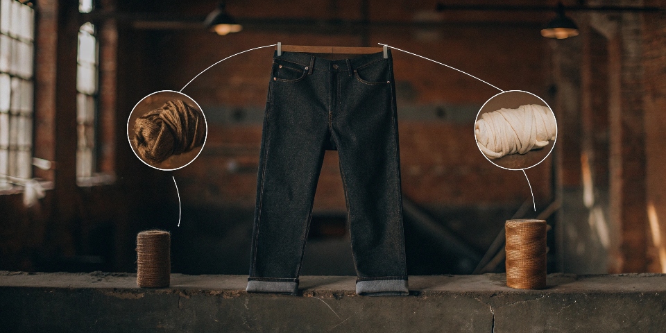 An infographic showing a cotton boll, a strand of [elastane](https://ecoalf.com/en-us/pages/what-is-elastane-advantages-uses-clothing)[^1], and a polyester thread all pointing towards a pair of modern jeans.