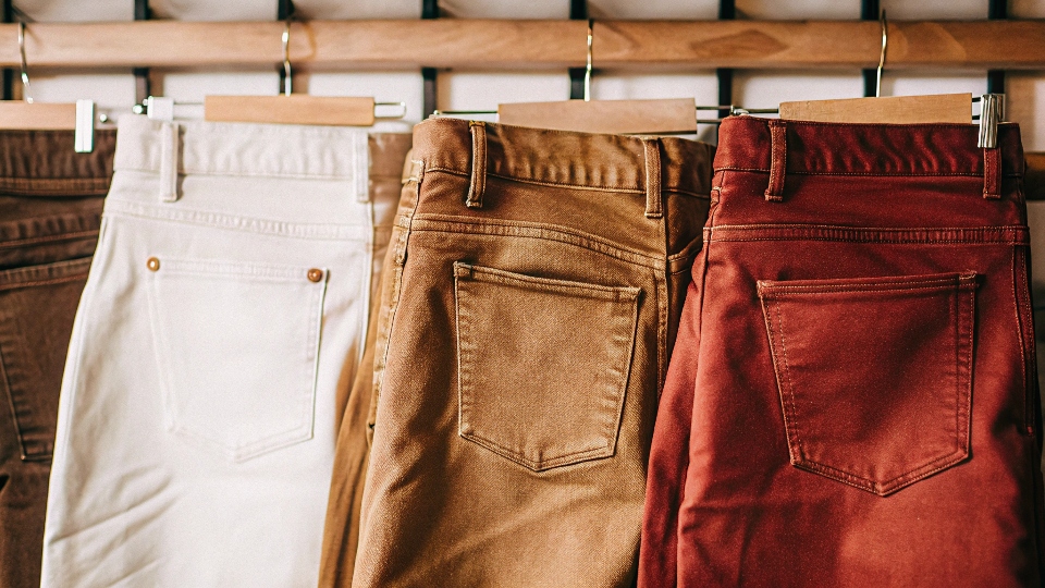 A lineup of jeans from different brands, showing the variety available to consumers.
