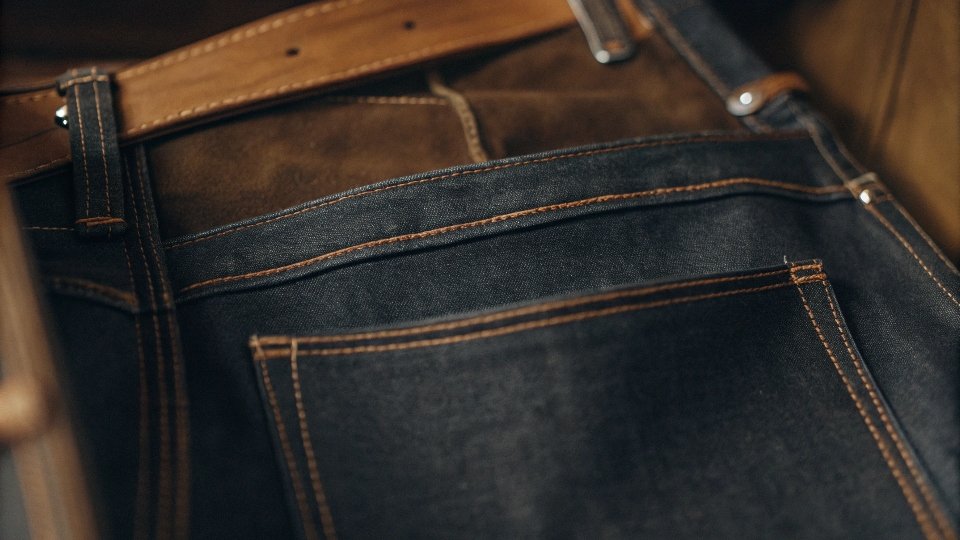 An inside-out view of a high-quality jean, showing clean internal stitching and a thick, sturdy pocket bag.