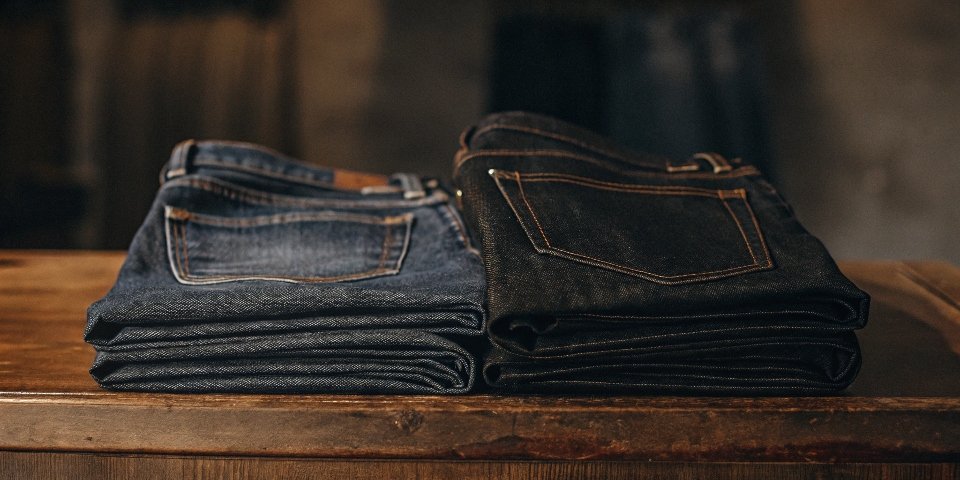 A pair of classic Lee Rider jeans folded neatly on a wooden surface.