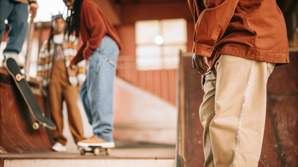 A collage of 90s hip-hop artists and skaters wearing iconic baggy jeans from the era.