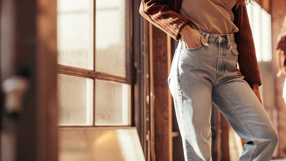 A woman wearing slouchy, low-slung boyfriend jeans, often with a rolled cuff, for a very relaxed look.