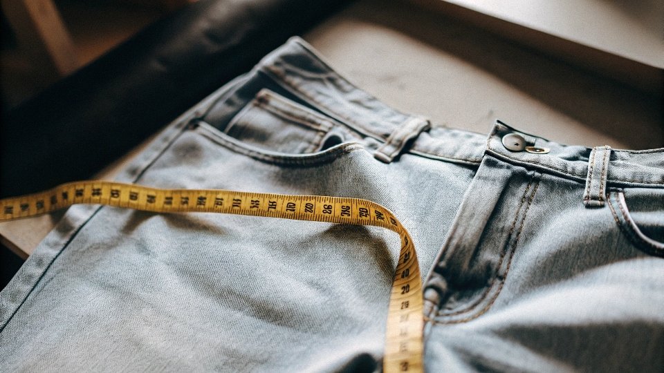 A yellow measuring tape indicating 1.75 yards on a flat piece of blue denim.