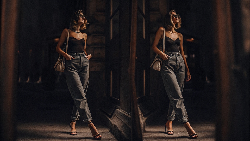 A woman looking stylish and chic in high-waisted baggy jeans paired with heels and a fitted top.