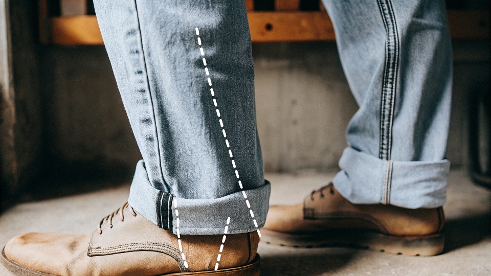 A diagram illustrating how an extra-long inseam on a jean leg compresses against a shoe to create "stacks".