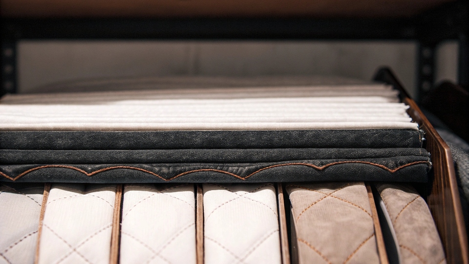 A display of different fabric swatches suitable for quilt backing, with flannel being the most prominent.