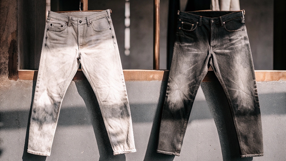 A side-by-side comparison of a faded pair of black jeans and the same pair after being re-dyed to a rich black.