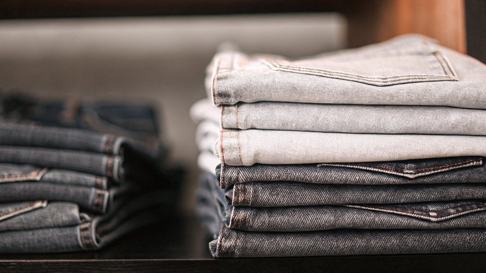 A stack of jeans in slightly different shades of blue, illustrating the concept of shade variation.