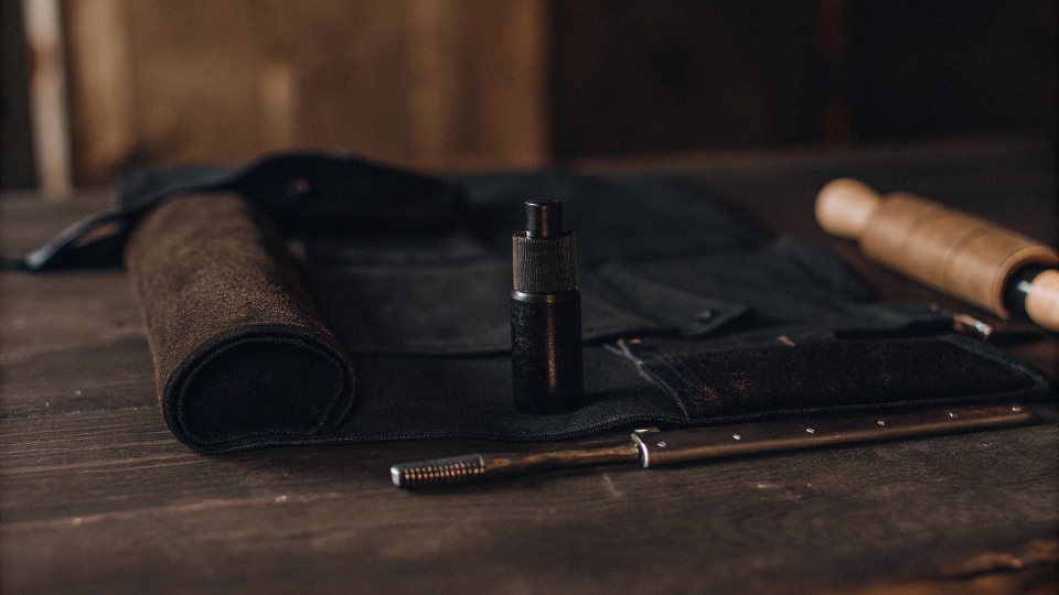 A toolkit for distressing jeans, including sandpaper, a seam ripper, and a spray bottle.