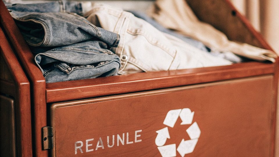A large collection bin specifically for recycling old denim clothes.