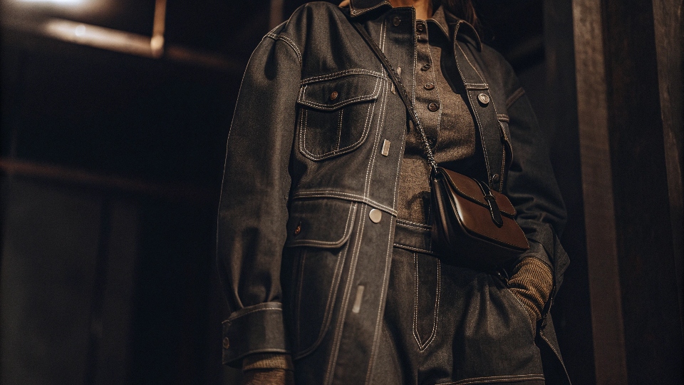 A fashion-forward image depicting a stylish outfit for 2025 that prominently features a denim jacket.