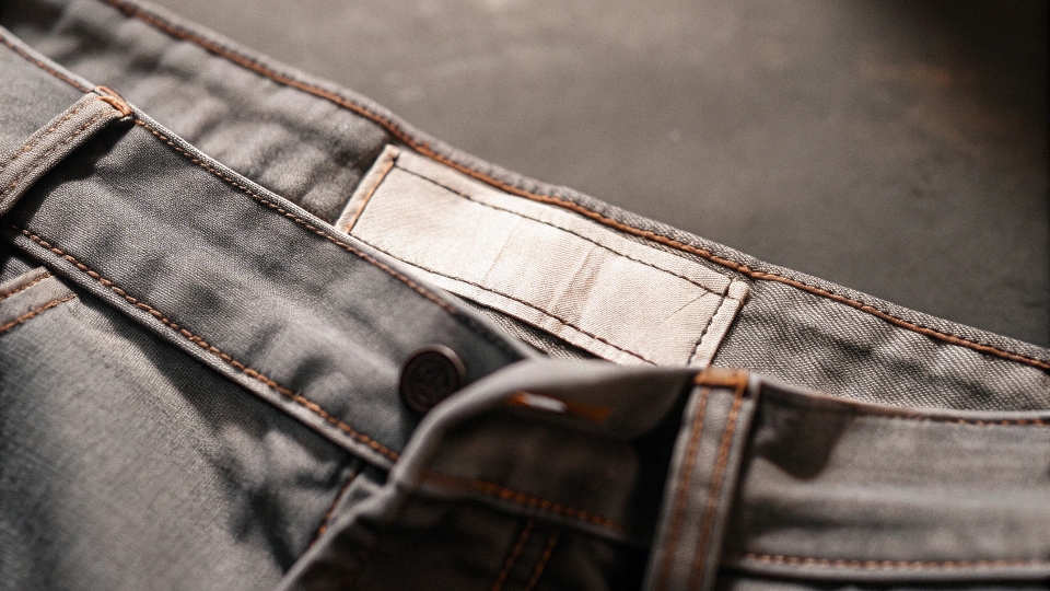 A close-up shot of the woven waistband tag on a pair of Valabasas jeans, clearly showing the brand name and details.