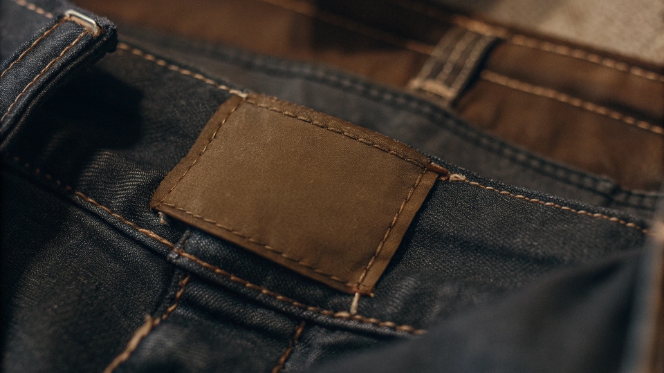 A close-up shot of a fabric composition tag inside a pair of jeans, with the 98% Cotton 2% Elastane highlighted.
