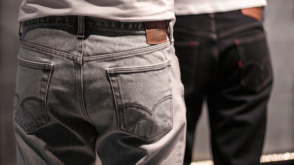 A classic Levi's red tab on the back pocket of a pair of jeans