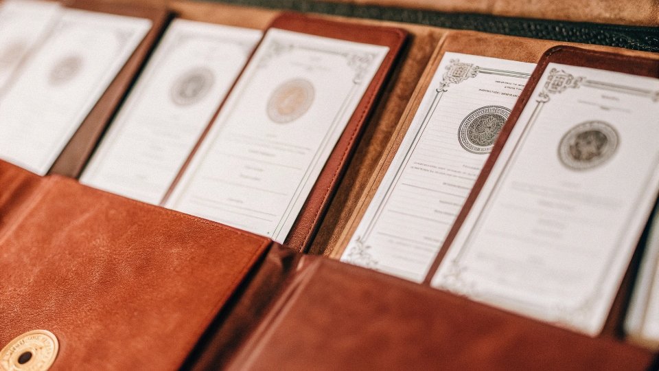 A collection of official-looking certificates and licenses with stamps on them