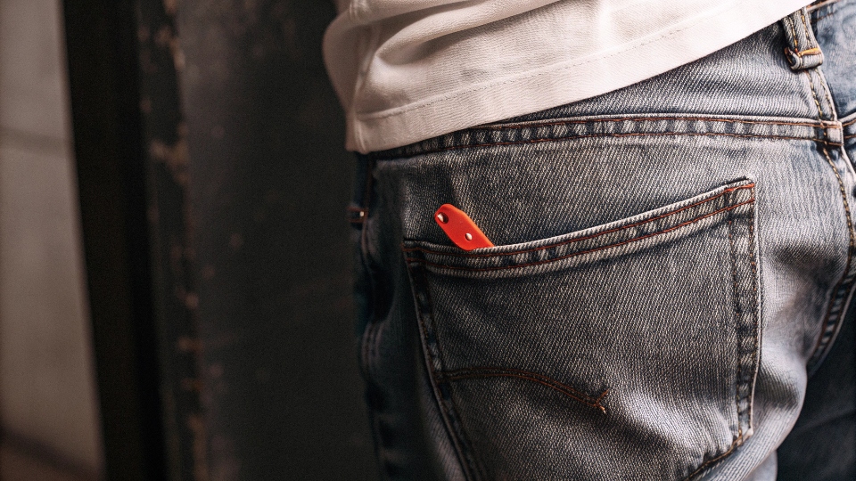 The iconic red tab on the back pocket of a pair of Levi's jeans
