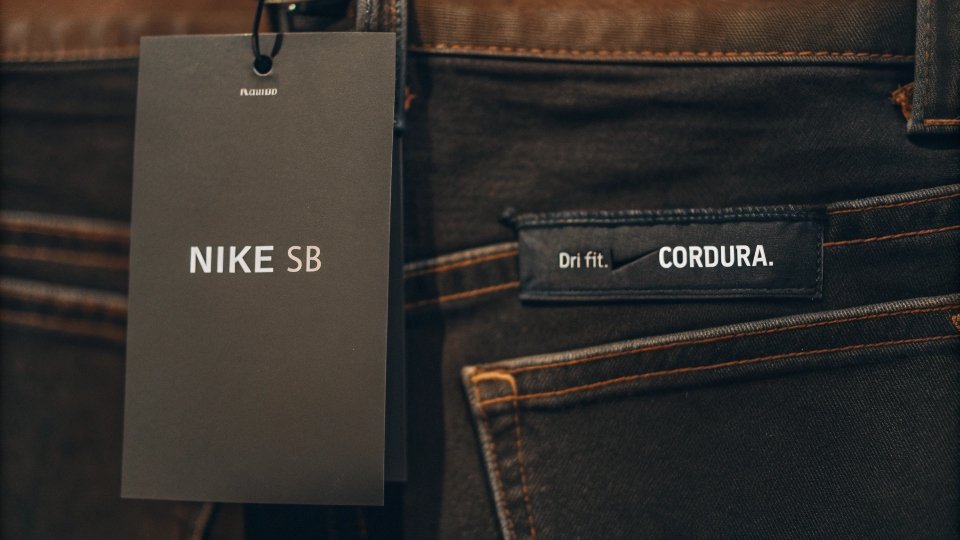 A price tag on a pair of Nike SB jeans, with the background showing the high-quality stitching and fabric