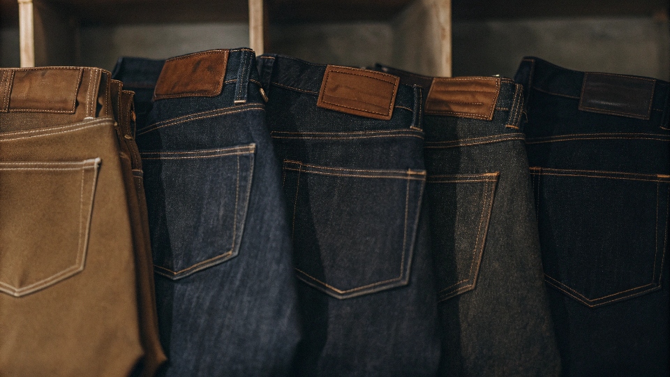 A collection of high-quality denim jeans from heritage and premium brands neatly folded