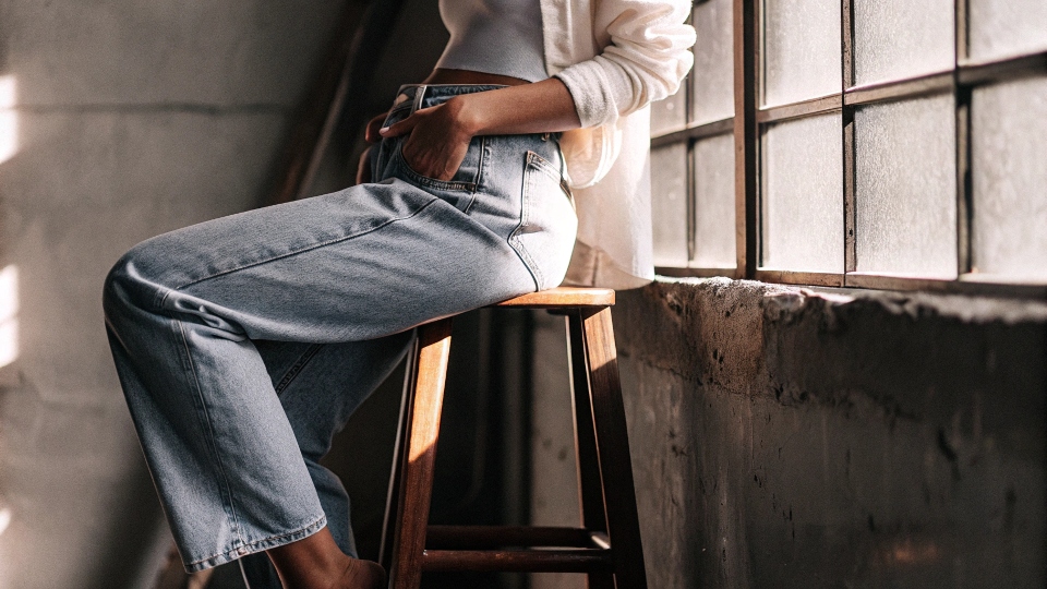 A person confidently wearing jeans that may not be from their 'gendered' section in a store