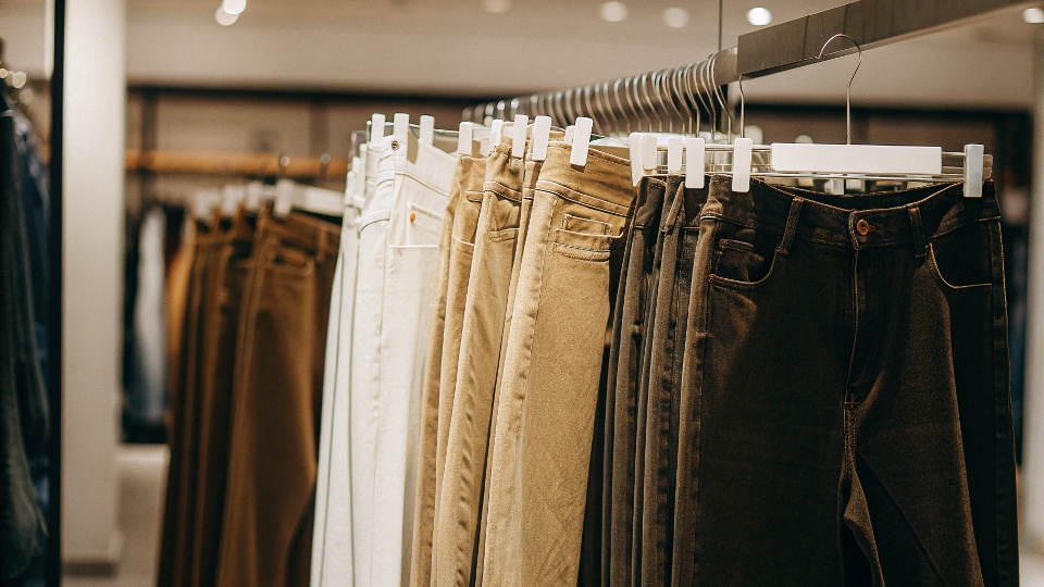 A clothing rack in a store showing Pepe Jeans alongside other popular international denim brands