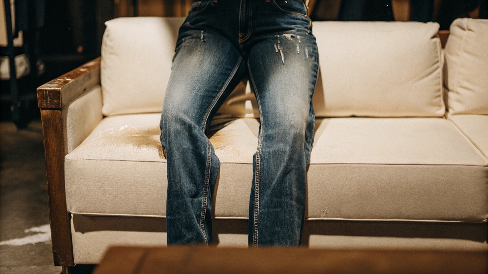 A white couch stained blue from someone sitting on it while wearing new H&M jeans