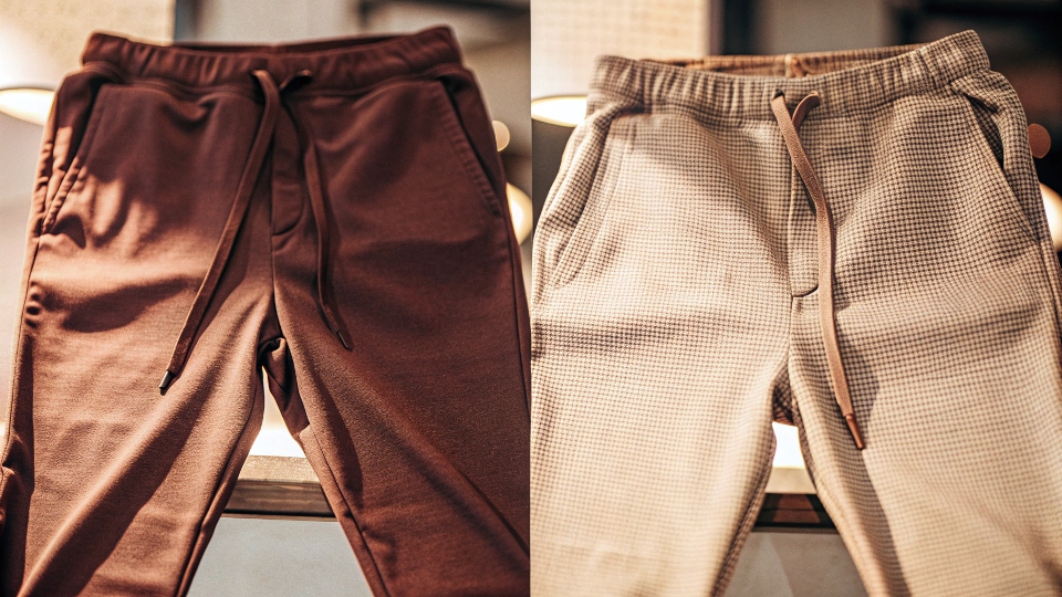 A side-by-side comparison of a pair of knit joggers and a pair of woven chinos