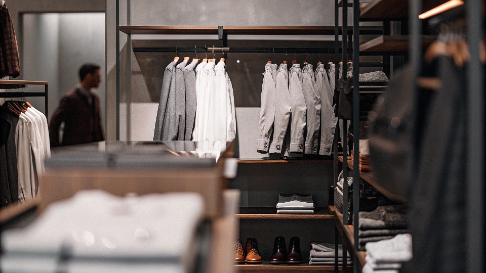 Interior shot of a bright, well-organized Banana Republic retail store contrasted with a more crowded outlet store