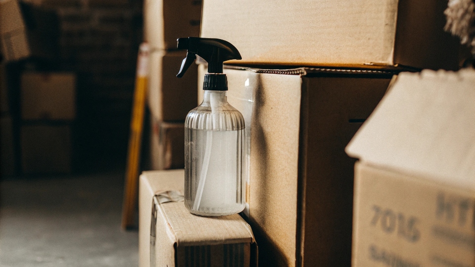 Boxes of baking soda and a bottle of white vinegar positioned as a powerful cleaning duo.