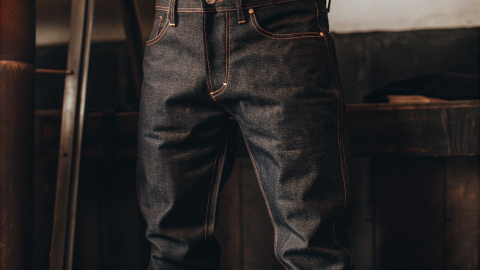 A pair of rugged, heavyweight [raw denim](https://diznewjeans.com/raw-denim-vs-washed-denim-which-one-should-you-buy/)[^3] jeans looking strong and ready for years of wear