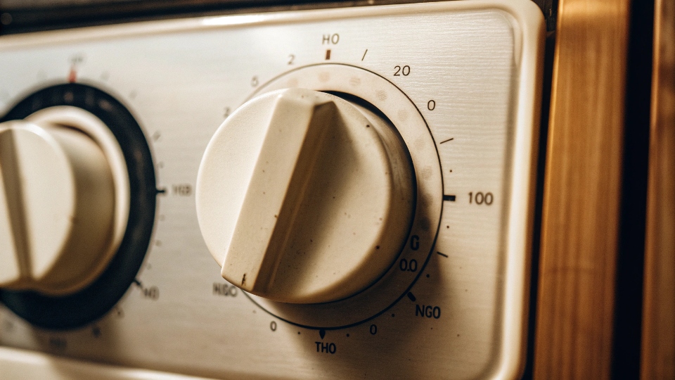 A close-up of a washing machine dial set to a hot water temperature