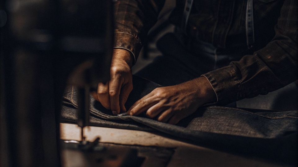 Tailor's chalk marking a new seam on a jean leg