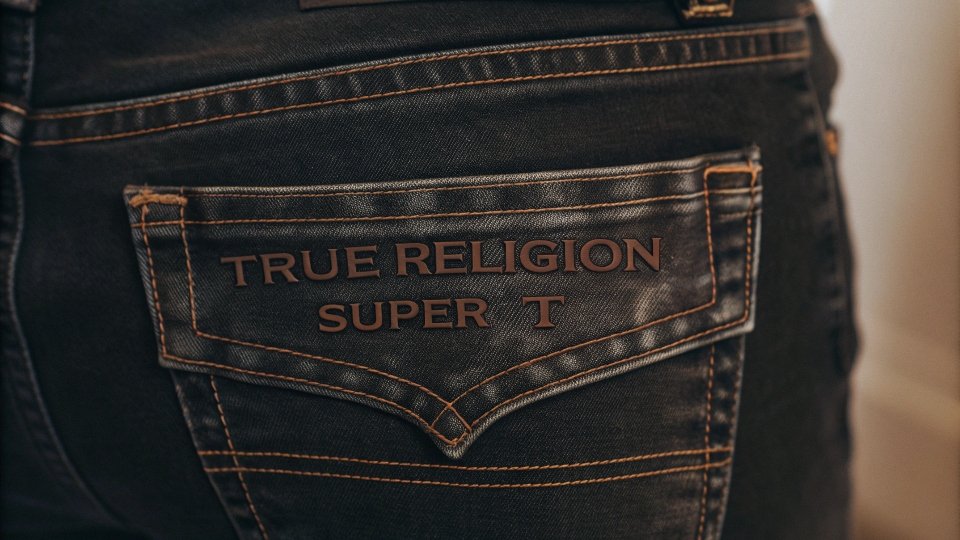 A close-up of True Religion's signature thick, contrasting [Super T stitch](https://www.truereligion.com/signature-stitch-womens-1?lang=default&srsltid=AfmBOooln7p7lIIK-DD78sRnsR1lOquQx58_oVgGp66w6GtbjEHeJQY5)[^4] on the back pocket