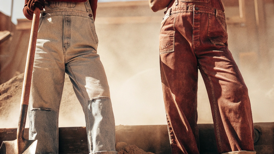 A black and white photograph of old-time miners wearing rugged denim work pants