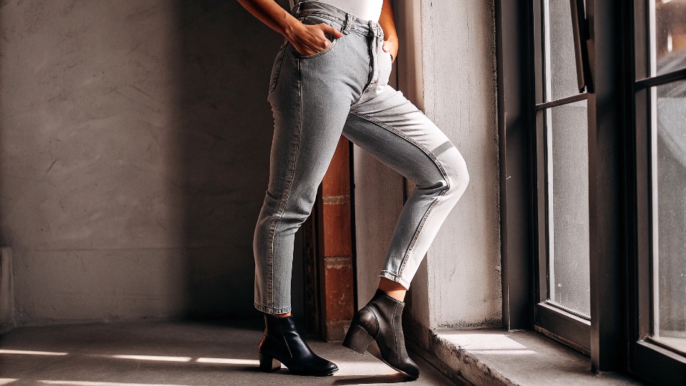 A stylish man confidently wearing a pair of slim-fitting jeans originally designed for women