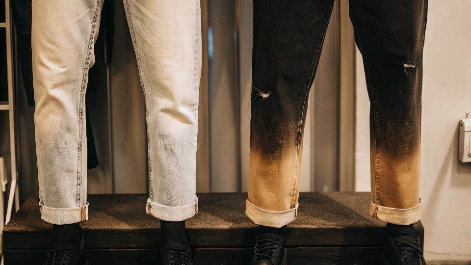 A before-and-after image showing a new pair of Uniqlo jeans next to a well-worn pair with natural fades