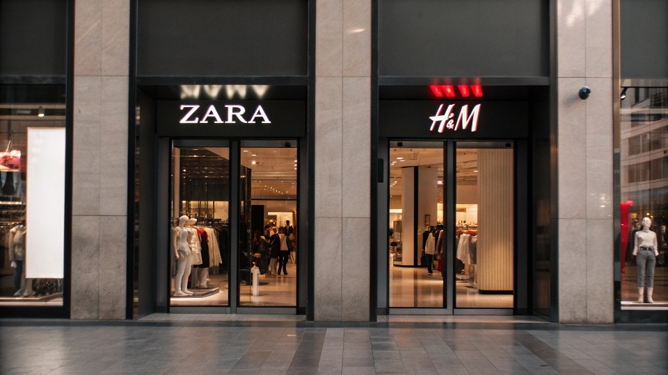 A Zara store entrance next to an H&M store entrance in a shopping mall