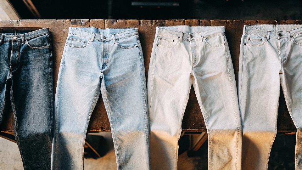 An image showing jeans in four [stages of bleaching](https://diznewjeans.com/what-are-the-raw-materials-required-for-making-denim-jeans-2/)[^10]: dark blue, sky blue, cream, and near-white
