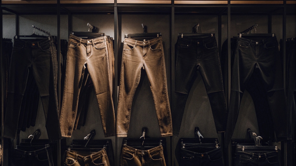 A retail wall of jeans showing only mid and high-rise styles