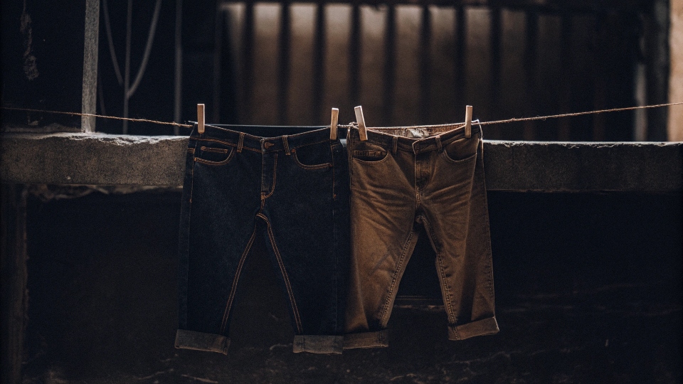 A pair of inside-out jeans hanging on a clothesline to air dry