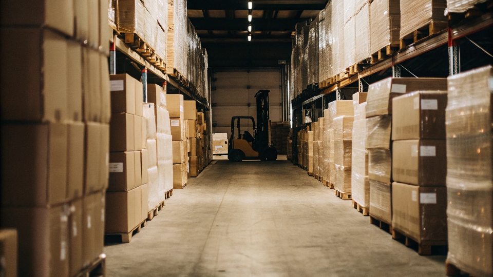 A warehouse aisle filled with boxes of wholesale clothing ready for shipping