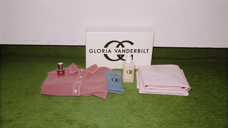 A display of various Gloria Vanderbilt products, including jeans, perfume, and blouses