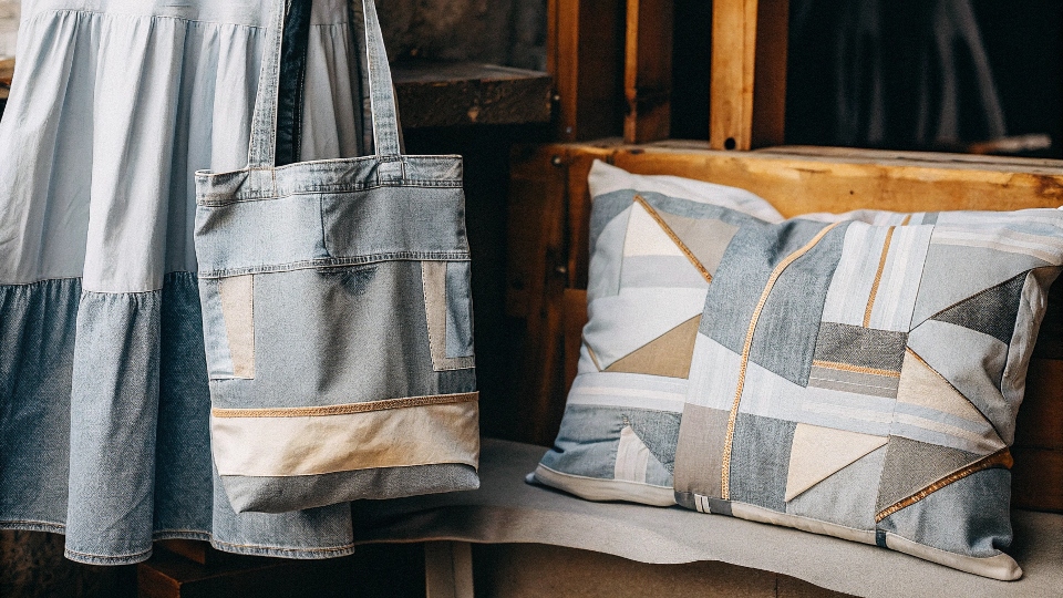 A collection of items made from upcycled jeans, including a [tote bag](https://diznewjeans.com/how-to-make-bags-from-old-jeans-step-by-step/)[^3], a skirt, and pillow covers