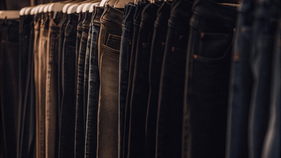 A closet with a row of skinny jeans next to newer, wider-leg styles
