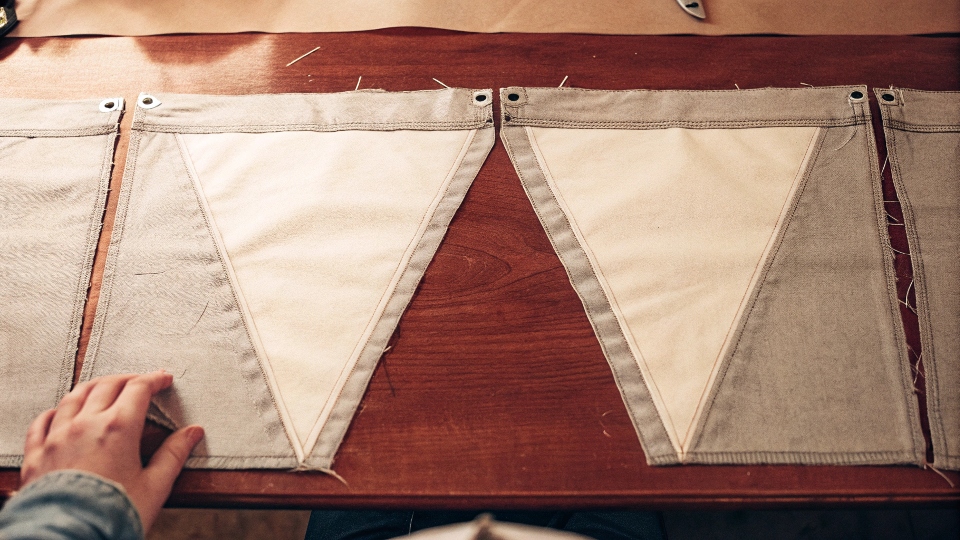 Opened inseam of jeans laid flat, showing the triangular gaps to be filled