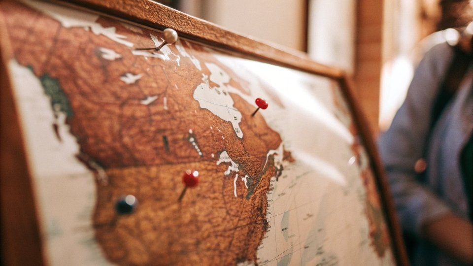 A world map with pins on France, the USA, Japan, Italy, and China