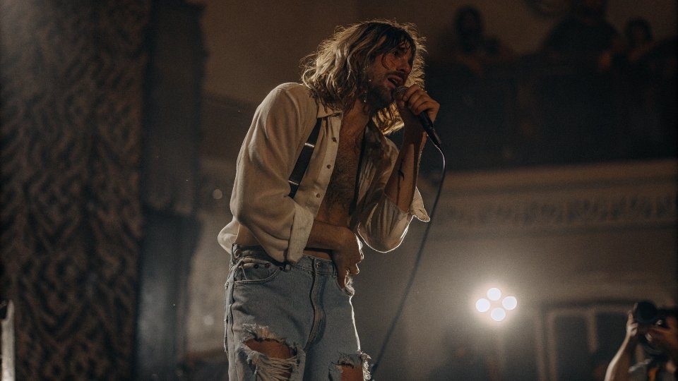 An iconic photo of Kurt Cobain performing in his signature ripped jeans