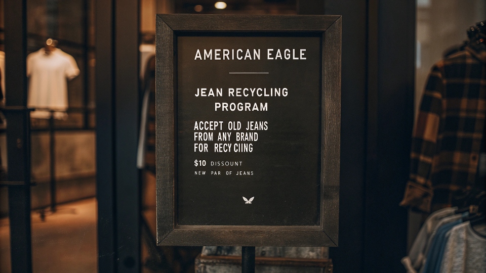 A sign in an American Eagle store advertising their Jean Recycling Program